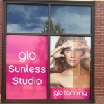 Glo Tanning poster on a window.
