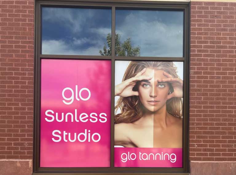 Glo Tanning poster on a window.