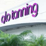 Glo tanning logo on a building.