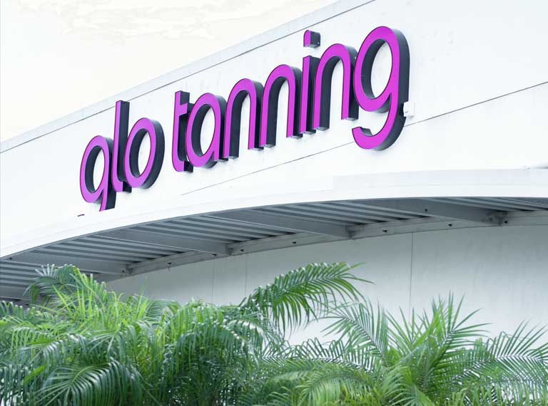 Glo tanning logo on a building.