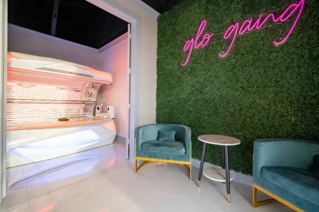 Two chairs with a glo tanning logo above it.